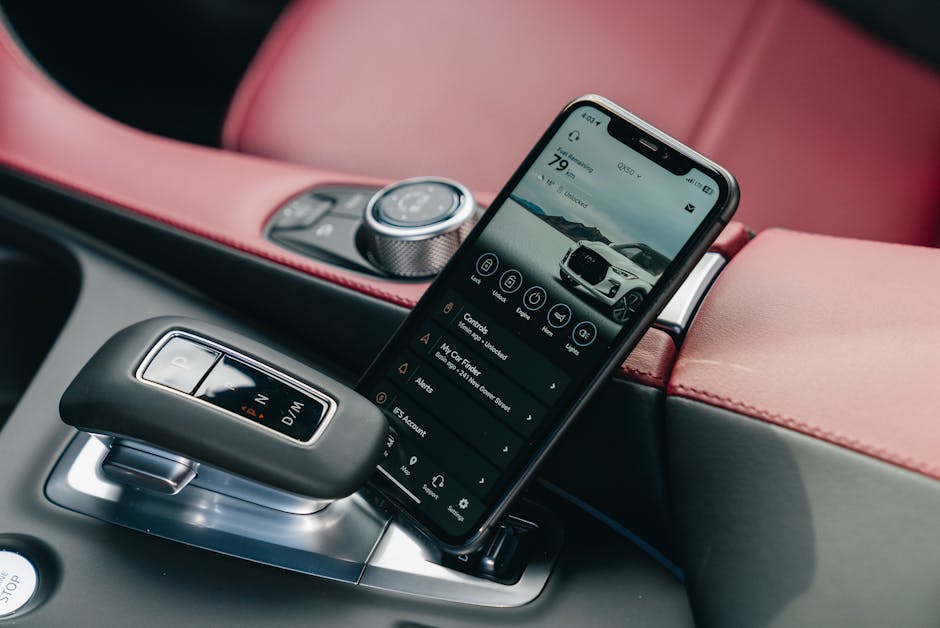 Close-up of smartphone with car control app in a luxury car's interior, showcasing modern technology